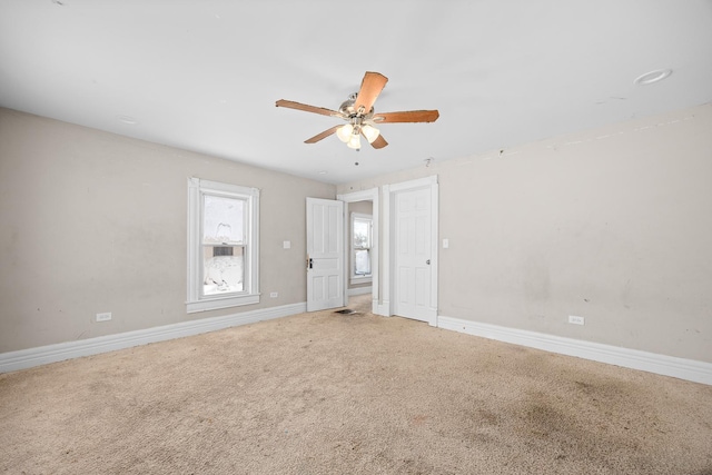 unfurnished room featuring ceiling fan, carpet floors, and baseboards