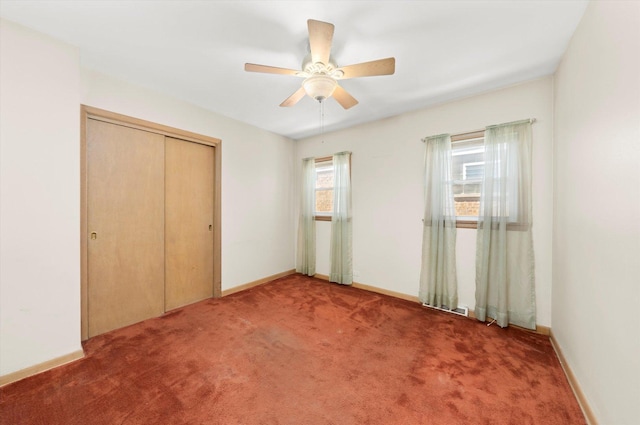 unfurnished bedroom featuring ceiling fan, carpet floors, and a closet