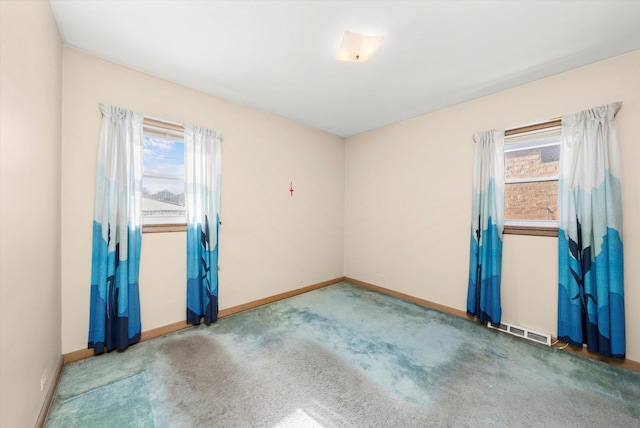 carpeted spare room with a wealth of natural light