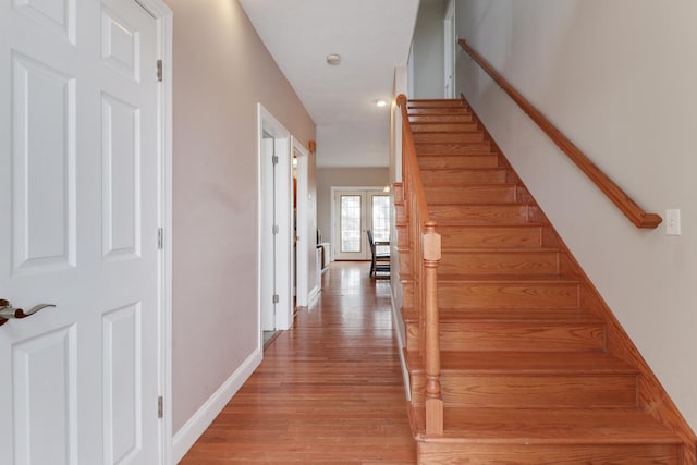 staircase with hardwood / wood-style flooring