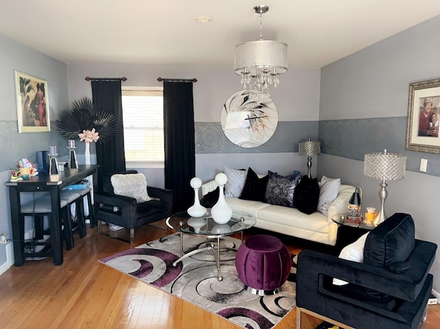 living room with a notable chandelier and hardwood / wood-style floors