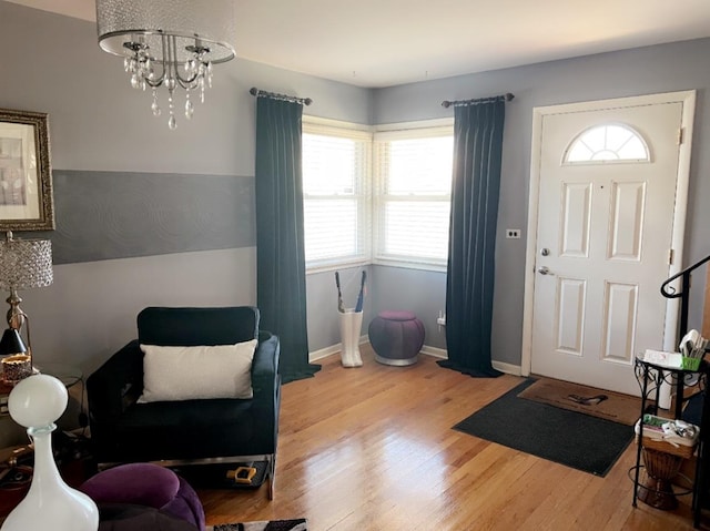 entrance foyer featuring a notable chandelier and light hardwood / wood-style floors