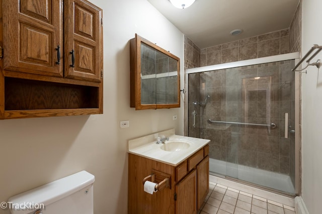 bathroom featuring vanity, tile patterned flooring, toilet, a baseboard radiator, and a shower with door