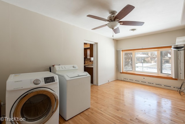 clothes washing area with light hardwood / wood-style flooring, ceiling fan, separate washer and dryer, and a baseboard radiator