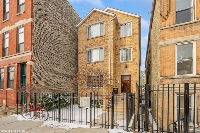 view of front facade featuring a fenced front yard and brick siding