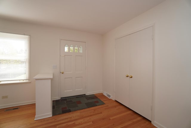 entryway featuring visible vents, light wood-style flooring, and a healthy amount of sunlight