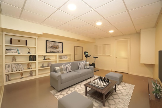 living area featuring recessed lighting, a drop ceiling, and baseboards