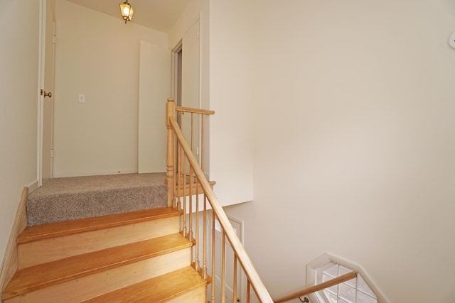 stairway with wood finished floors