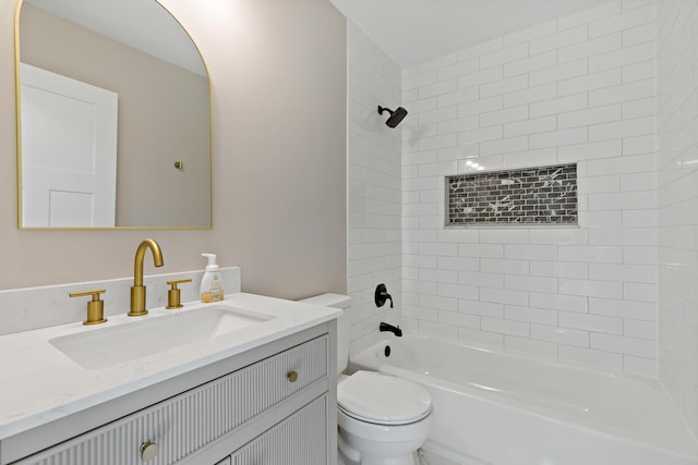 full bathroom with toilet, vanity, and tiled shower / bath