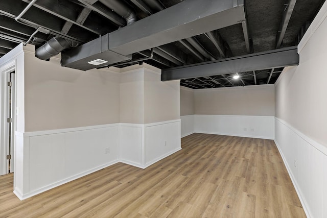 basement with light hardwood / wood-style flooring