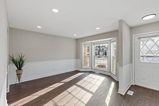 foyer entrance featuring dark wood-type flooring