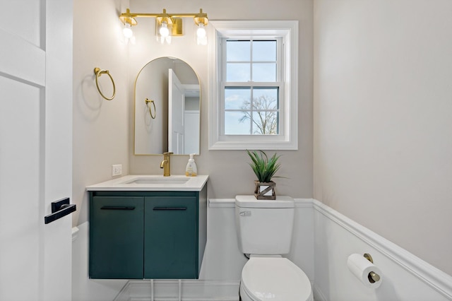 bathroom featuring toilet and vanity