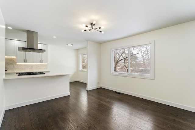 unfurnished living room with dark hardwood / wood-style floors