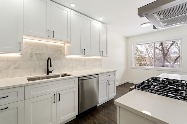 kitchen with white cabinetry, sink, backsplash, dishwasher, and dark hardwood / wood-style floors