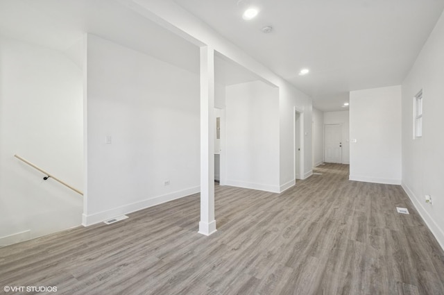 below grade area featuring light wood-style flooring, visible vents, baseboards, and recessed lighting