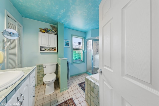 full bathroom featuring tile patterned floors, toilet, vanity, and independent shower and bath