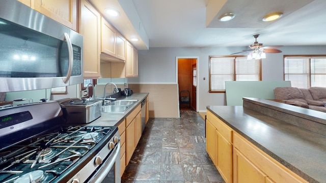 kitchen with ceiling fan, sink, stainless steel appliances, and light brown cabinetry