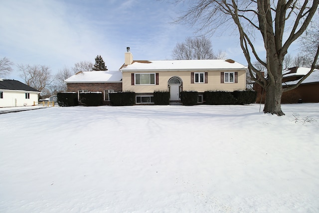 split foyer home featuring a chimney