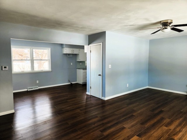 unfurnished room featuring dark wood-type flooring and ceiling fan