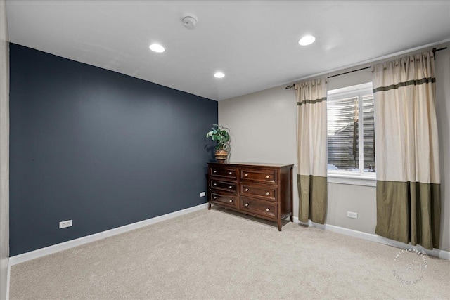 unfurnished room featuring light colored carpet