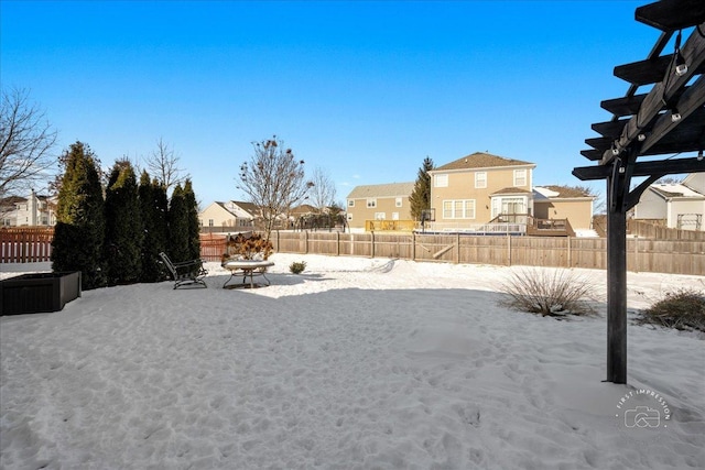 snowy yard featuring a pergola