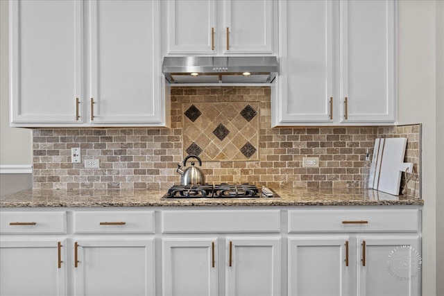 kitchen featuring extractor fan, white cabinets, and light stone countertops