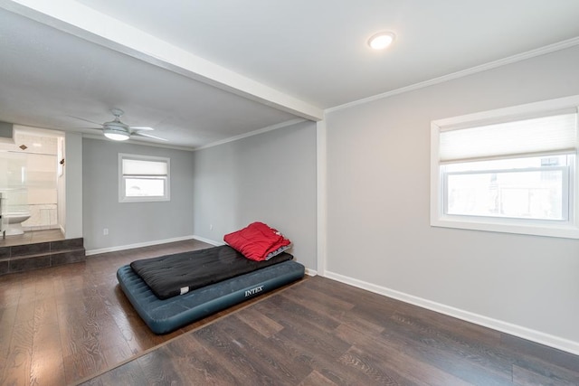 interior space featuring ornamental molding, dark wood-style flooring, ensuite bath, and baseboards