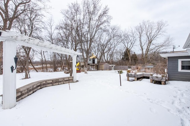 yard covered in snow with a pergola