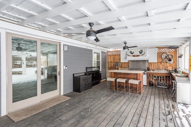 wooden terrace with ceiling fan and outdoor dry bar