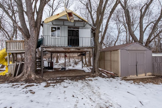 exterior space featuring a garage, a storage unit, and an outdoor structure