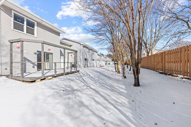 exterior space featuring fence and a deck