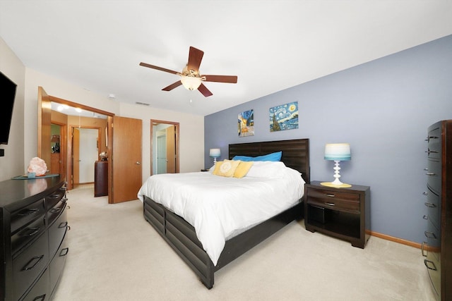 bedroom with light colored carpet, ceiling fan, and baseboards