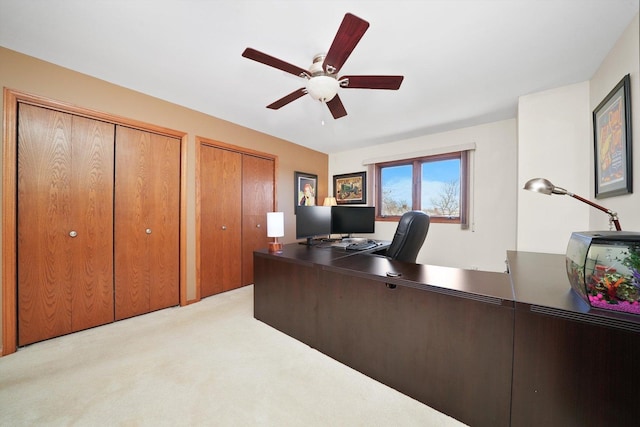 office area featuring a ceiling fan and light carpet