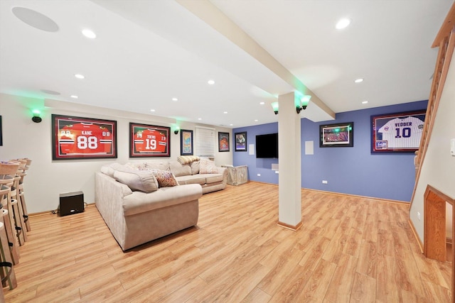 living room featuring light wood finished floors, baseboards, and recessed lighting