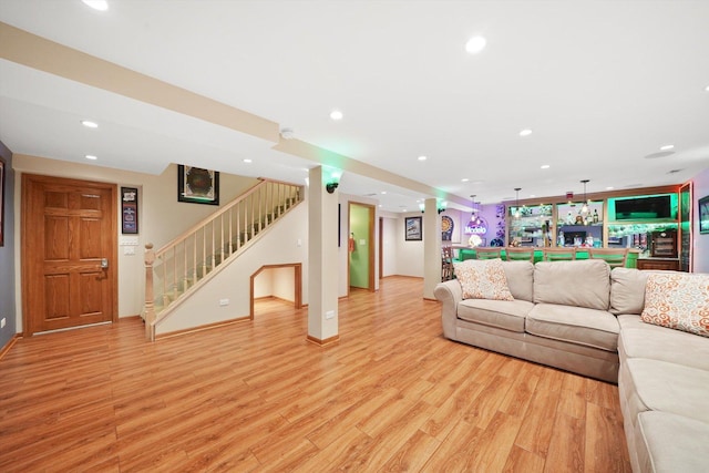 living room with stairs, light wood-style flooring, and recessed lighting