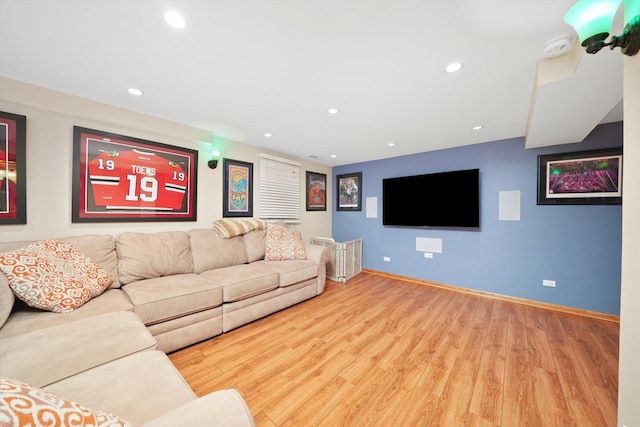 living area with recessed lighting, baseboards, and wood finished floors