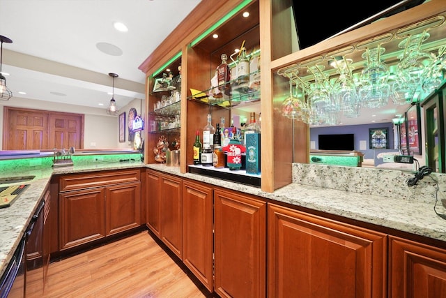 bar featuring light wood-style floors, recessed lighting, pendant lighting, and a dry bar