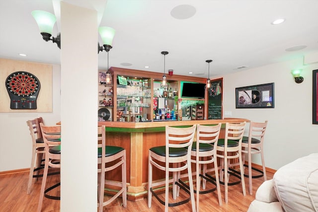 bar featuring recessed lighting, a dry bar, and wood finished floors