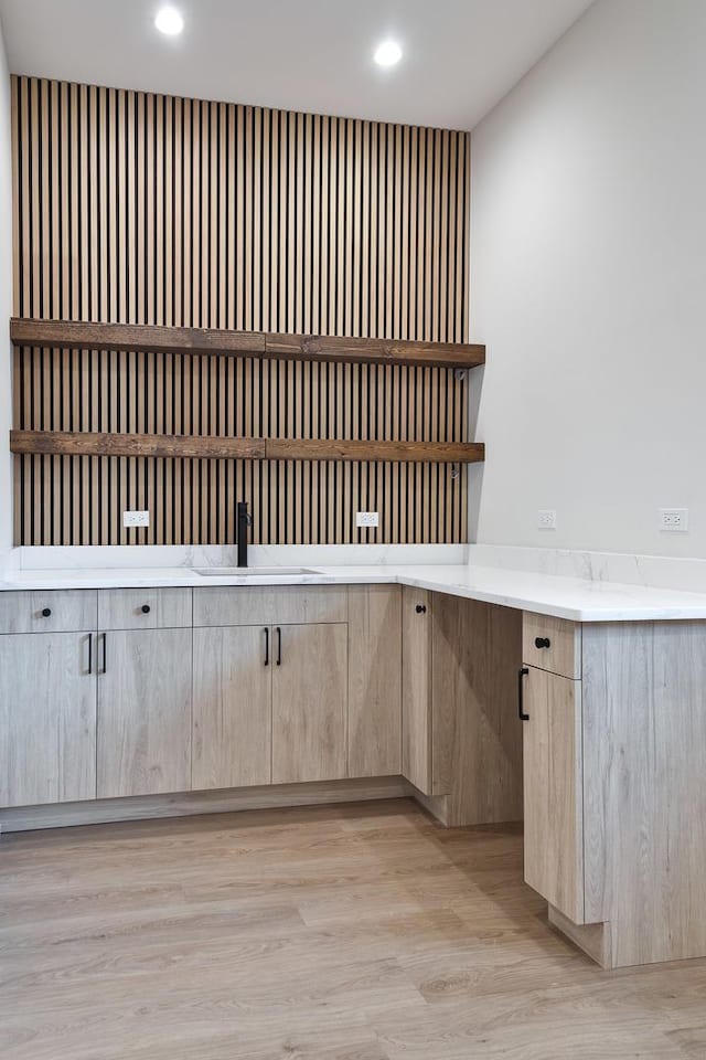 interior space featuring sink, light wood-type flooring, and light brown cabinetry