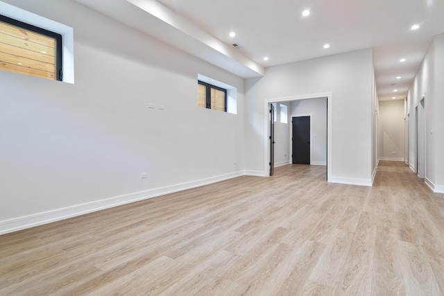 empty room with light hardwood / wood-style flooring