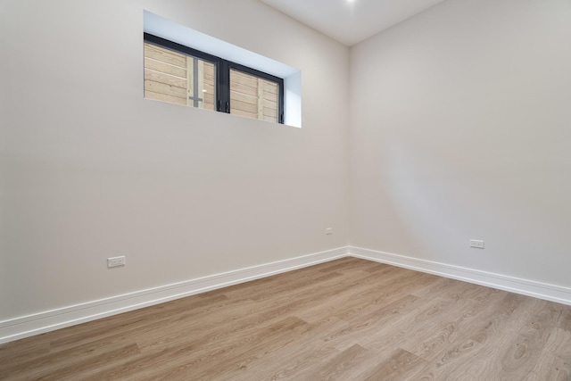 spare room with light hardwood / wood-style flooring