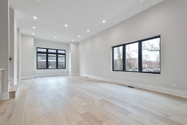 spare room with light hardwood / wood-style flooring