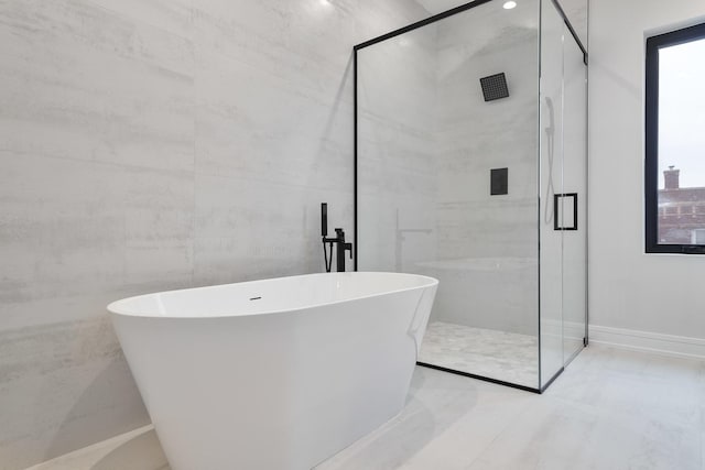 bathroom featuring shower with separate bathtub and a healthy amount of sunlight