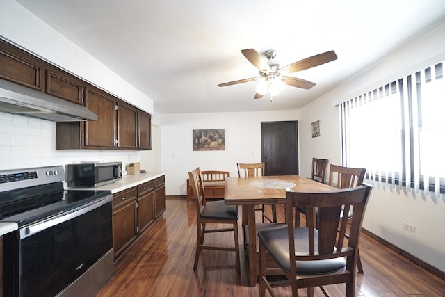 kitchen featuring appliances with stainless steel finishes, dark brown cabinets, dark hardwood / wood-style floors, and decorative backsplash