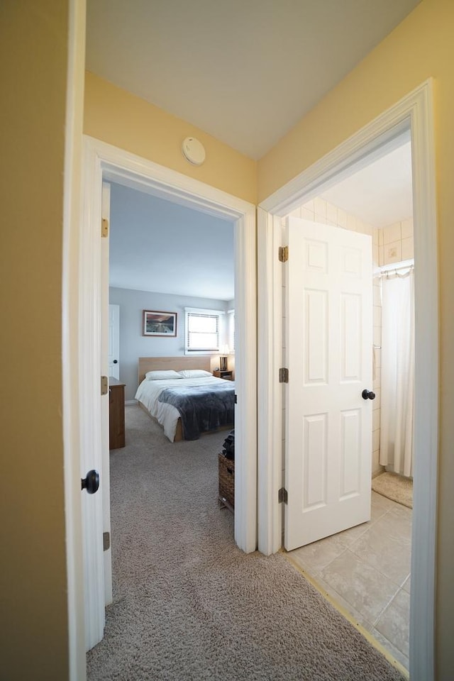 hallway featuring light colored carpet