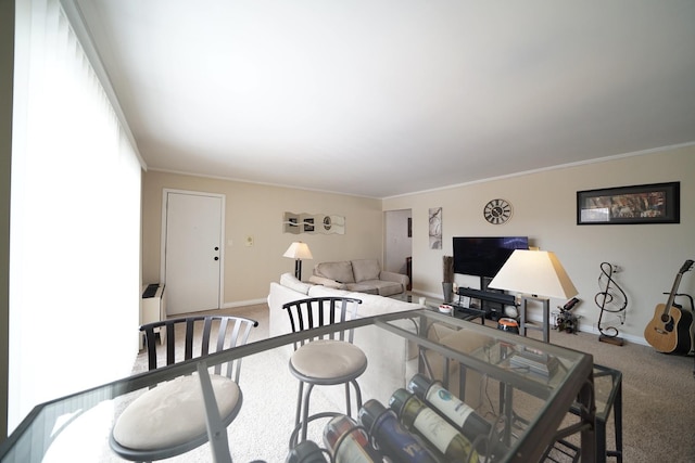 dining area with ornamental molding and carpet floors