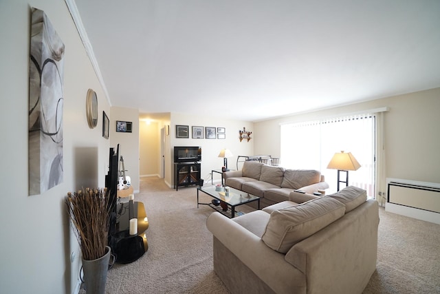 living room with a baseboard heating unit and light colored carpet