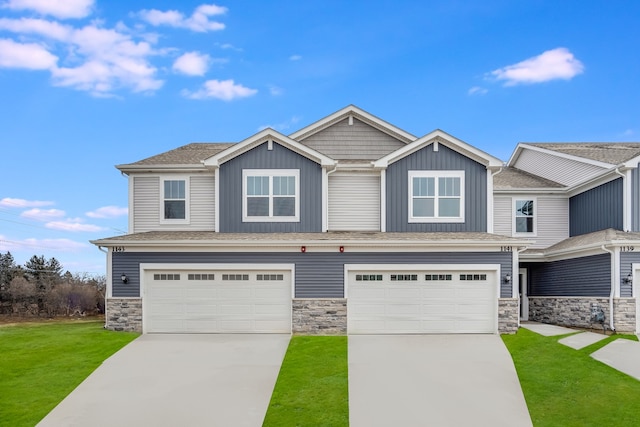 view of front of home with a garage, driveway, and a front lawn