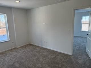 empty room with dark carpet