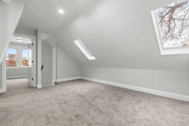 bonus room featuring baseboards, carpet floors, recessed lighting, and lofted ceiling with skylight